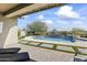 Covered patio overlooking a refreshing pool and spa at 2229 N Beverly Pl, Buckeye, AZ 85396