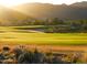 Golf course with scenic mountain views at sunset at 2229 N Beverly Pl, Buckeye, AZ 85396