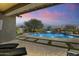 Inviting backyard pool with a water feature and patio furniture at 2229 N Beverly Pl, Buckeye, AZ 85396