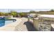 Outdoor kitchen and pool with built-in BBQ and spa at 2229 N Beverly Pl, Buckeye, AZ 85396