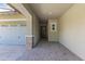 View of a home's entryway from the garage, featuring a gray door and brick columns at 2229 N Beverly Pl, Buckeye, AZ 85396