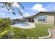 Landscaped backyard featuring a pool, spa, and grassy area at 2229 N Beverly Pl, Buckeye, AZ 85396