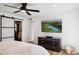 Bright bedroom with large TV, walk-in closet, and dresser at 8320 E Appaloosa Trl, Scottsdale, AZ 85258