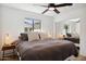 Comfortable bedroom with king bed, window, and ceiling fan at 8320 E Appaloosa Trl, Scottsdale, AZ 85258