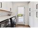 Clean laundry room with white cabinets, washer, dryer, and backyard access at 8320 E Appaloosa Trl, Scottsdale, AZ 85258