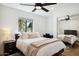 Bright bedroom with a queen-size bed, desk, and mirrored closet at 8320 E Appaloosa Trl, Scottsdale, AZ 85258