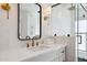 Elegant bathroom with gold fixtures, white vanity, and a frameless mirror at 8320 E Appaloosa Trl, Scottsdale, AZ 85258