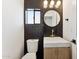 Modern bathroom with dark tile and gold fixtures at 8320 E Appaloosa Trl, Scottsdale, AZ 85258