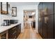 Butler's pantry with dark cabinets and wine storage at 8320 E Appaloosa Trl, Scottsdale, AZ 85258