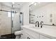 Clean bathroom with white vanity, black accents, and glass shower at 8320 E Appaloosa Trl, Scottsdale, AZ 85258