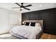 Spacious bedroom with king-size bed, dark accent wall, and ceiling fan at 8320 E Appaloosa Trl, Scottsdale, AZ 85258