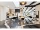 Sleek kitchen island with black marble countertop and built-in appliances at 8320 E Appaloosa Trl, Scottsdale, AZ 85258