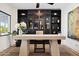 Modern home office with built-in shelving and large art piece at 8320 E Appaloosa Trl, Scottsdale, AZ 85258