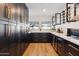 Modern kitchen with dark cabinetry and ample storage space at 8320 E Appaloosa Trl, Scottsdale, AZ 85258