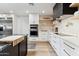 White kitchen with black countertops and gold accents at 8320 E Appaloosa Trl, Scottsdale, AZ 85258