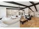 Bright living room with white sectional sofa, fireplace, and wood floors at 8320 E Appaloosa Trl, Scottsdale, AZ 85258