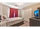 Small bedroom with TV and double closet at 32854 N Quail Ave, San Tan Valley, AZ 85144