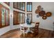 Charming dining room with a white table and chairs, and wood shutters at 14828 N 15Th Ave, Phoenix, AZ 85023