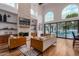 Spacious living room with hardwood floors, stone fireplace, and large windows at 14828 N 15Th Ave, Phoenix, AZ 85023
