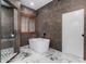 Spa-like bathroom with freestanding soaking tub and walk-in shower at 14828 N 15Th Ave, Phoenix, AZ 85023