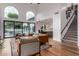 Open living space with hardwood floors, a view of the kitchen and backyard, and a staircase at 14828 N 15Th Ave, Phoenix, AZ 85023