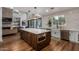 Modern kitchen with a large island, white cabinetry, and stainless steel appliances at 14828 N 15Th Ave, Phoenix, AZ 85023