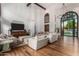 Large living area with hardwood floors, comfortable seating, and a high ceiling at 14828 N 15Th Ave, Phoenix, AZ 85023
