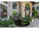 Charming courtyard with a tranquil water feature and lush greenery at 14828 N 15Th Ave, Phoenix, AZ 85023