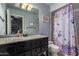 Clean bathroom with granite countertop and floral shower curtain at 14828 N 15Th Ave, Phoenix, AZ 85023