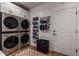 Bright laundry room with washer, dryer, and shoe organizer at 14828 N 15Th Ave, Phoenix, AZ 85023