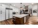 Modern kitchen with a large island and a stone fireplace at 14828 N 15Th Ave, Phoenix, AZ 85023