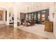 Bright and airy living room with a stone fireplace and access to the backyard at 37295 N Boulder View Dr, Scottsdale, AZ 85262