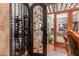 Built-in wine rack with glass door offering a view to the patio at 37295 N Boulder View Dr, Scottsdale, AZ 85262
