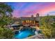 Luxury home with a pool and a beautiful sunset at 37295 N Boulder View Dr, Scottsdale, AZ 85262