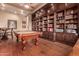 Game room with pool table and extensive built-in wooden shelving at 37295 N Boulder View Dr, Scottsdale, AZ 85262