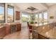 Well-appointed kitchen with granite countertops, wood cabinetry, and breakfast bar at 37295 N Boulder View Dr, Scottsdale, AZ 85262