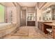 Spa-like bathroom with soaking tub, double vanity, and tile floors at 37295 N Boulder View Dr, Scottsdale, AZ 85262