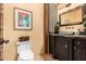 Stylish powder room with dark wood vanity and granite countertop at 37295 N Boulder View Dr, Scottsdale, AZ 85262