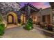 Charming courtyard entry with stone pillars, wrought iron door, and comfortable seating at 37295 N Boulder View Dr, Scottsdale, AZ 85262