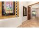 Elegant hallway with large artwork, mirror, and tile flooring at 37295 N Boulder View Dr, Scottsdale, AZ 85262