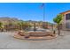 Gated community entrance with fountain and flag at 10410 N Cave Creek Rd # 2224, Phoenix, AZ 85020