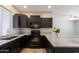 Modern kitchen with dark cabinets and granite countertops at 11235 E Pampa Ave, Mesa, AZ 85212