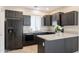 Modern kitchen with dark cabinets and granite countertops at 11235 E Pampa Ave, Mesa, AZ 85212