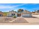 White single story home with a two-car garage and nicely landscaped front yard at 1365 W Laguna Azul Ave, Mesa, AZ 85202
