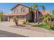 Two-story house with a two-car garage and palm trees at 5540 W Lone Cactus Dr, Glendale, AZ 85308