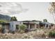 Contemporary home with stone facade and desert landscaping at 10071 E Aniko Dr, Scottsdale, AZ 85262
