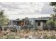 Modern home with stone accents and a backyard patio at 10071 E Aniko Dr, Scottsdale, AZ 85262