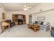 Bright living room features comfy seating, built-in shelving, and a ceiling fan at 1729 Leisure World --, Mesa, AZ 85206