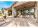 Covered patio with flagstone flooring, ceiling fan, and outdoor seating at 27476 N 125Th Dr, Peoria, AZ 85383