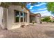 Charming backyard with gravel landscaping, patio, and mature trees at 27476 N 125Th Dr, Peoria, AZ 85383